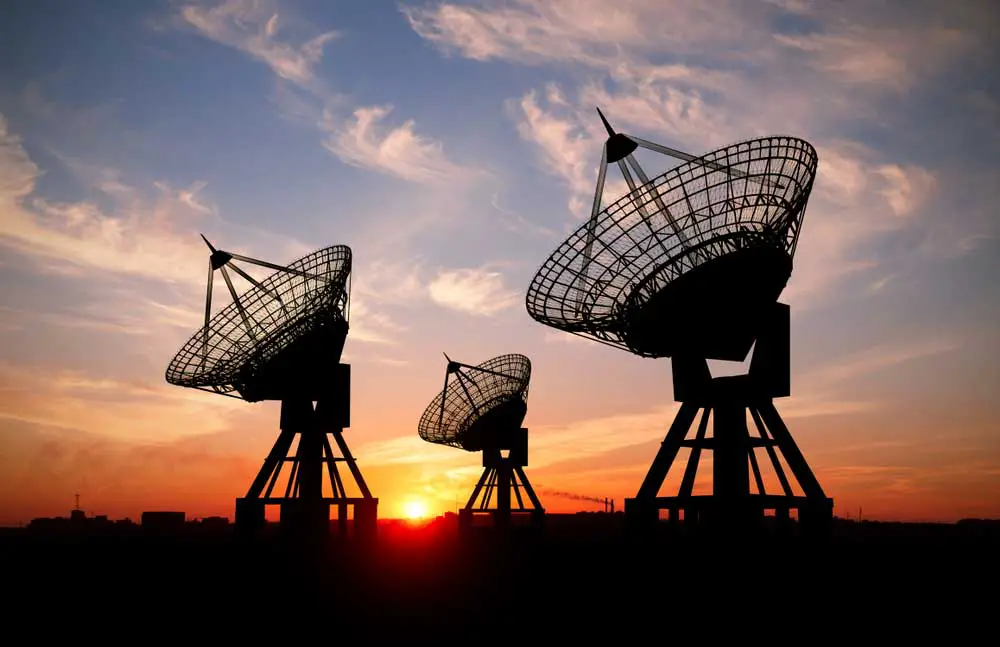 Starlink Installation: Three satellite dishes at sunset