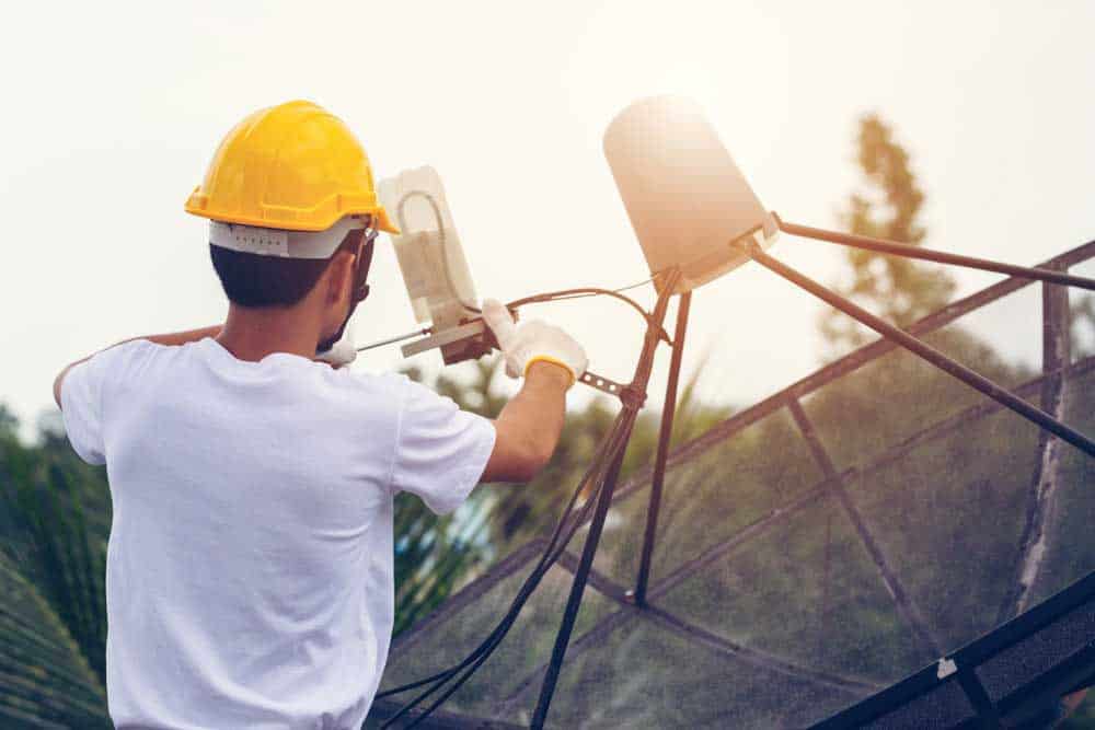 Starlink Installation: The technician is installing the satellite receiver.