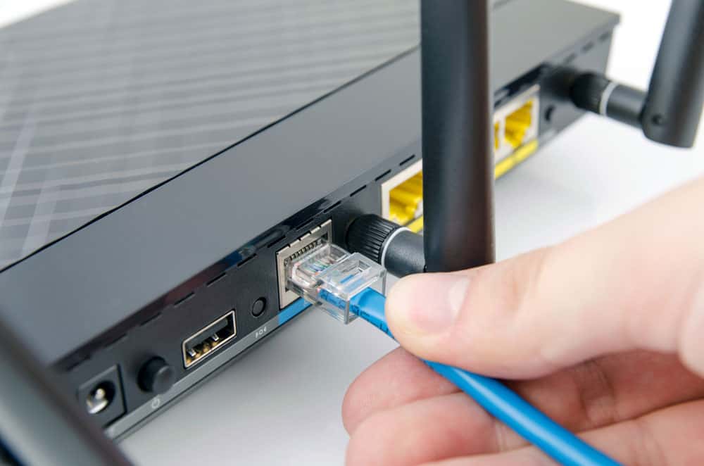 Image of plugging in a cable into the router