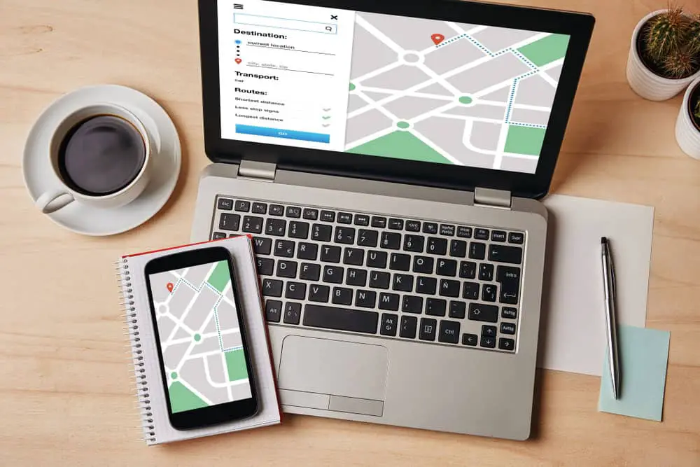 GPS map navigation app on laptop and smartphone
