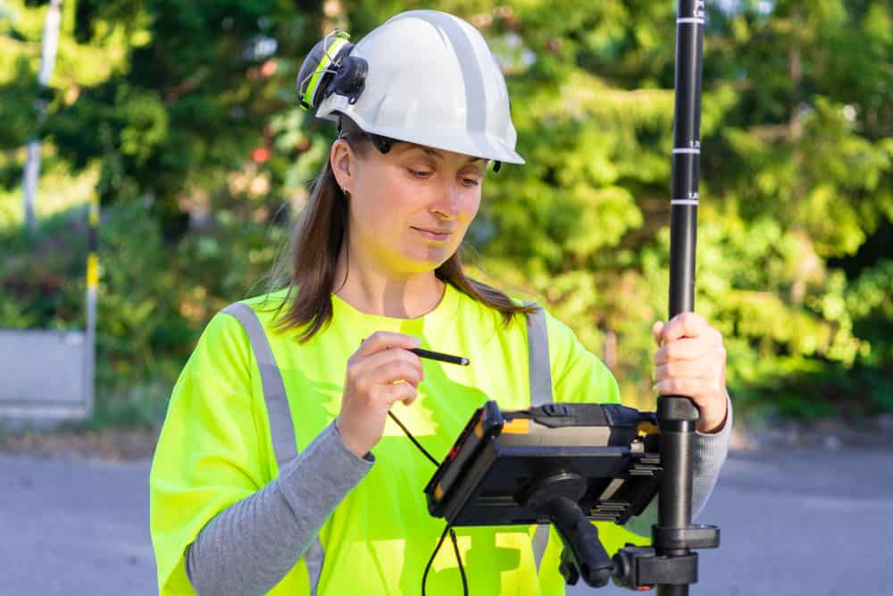 A surveyor with a land surveying tool