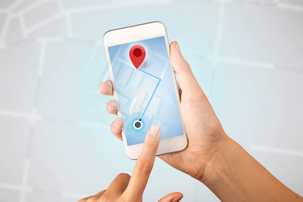 Female touching smartphone with map 