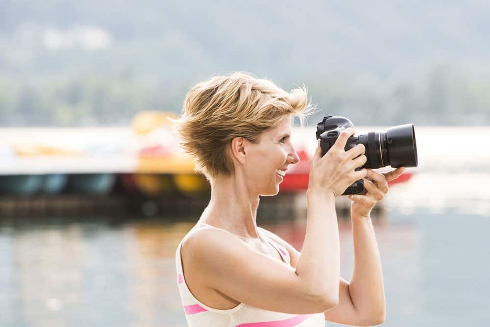 A woman taking photos on her DSLR camera