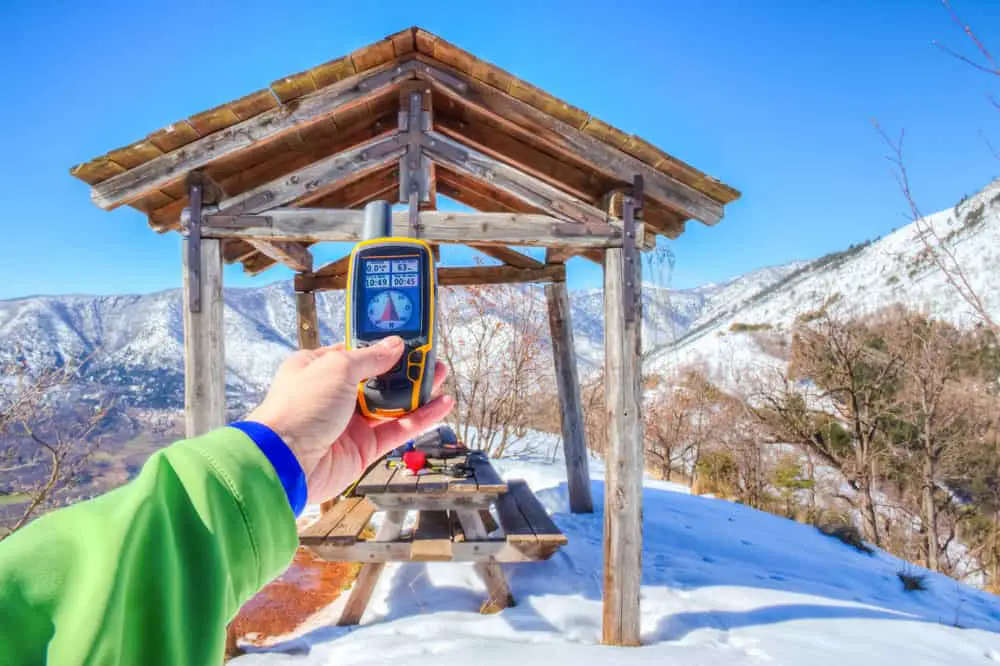 A hiker with a GPS receiver in the mountains