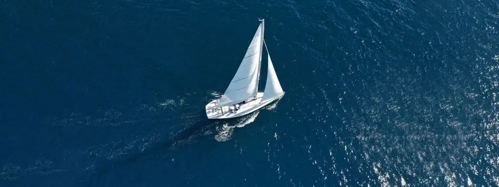 Beautiful sailboat cruises the deep blue open ocean