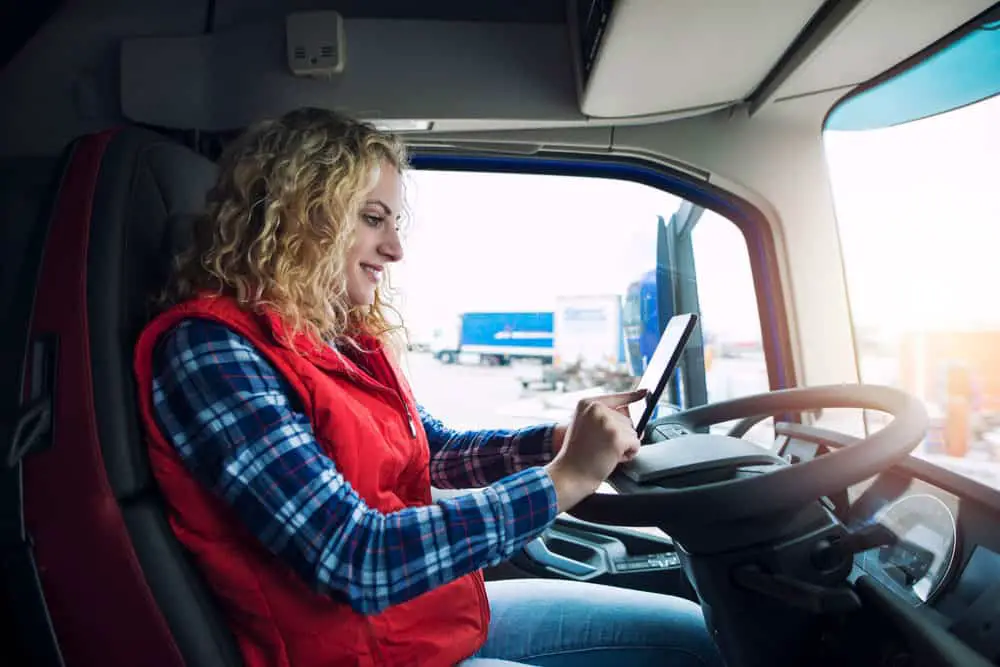  truck driver planning routes on her tablet