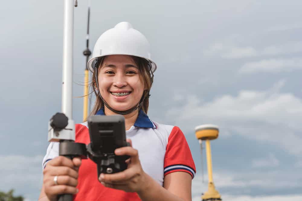 A geodetic engineer using a GNSS RTK receiver 