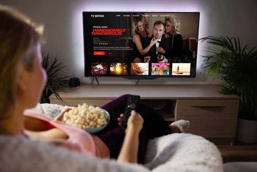 A woman streaming a movie on Netflix