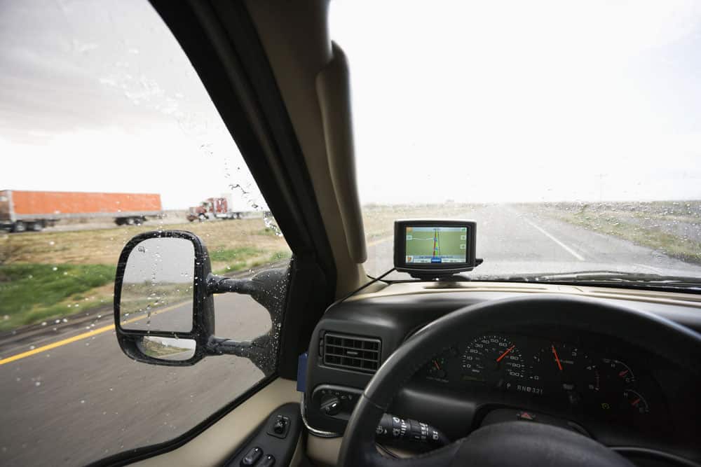 A view of a truck dashboard GPS via the windshield