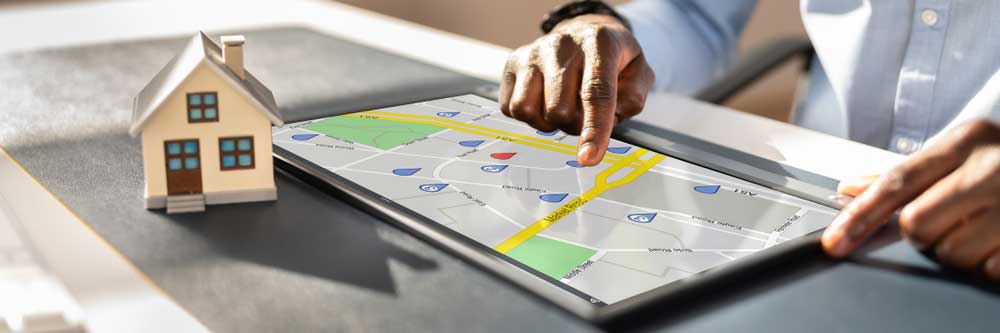 A person using a map application on a tablet to identify property lines