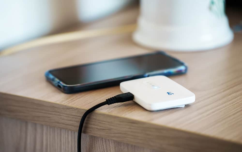 A pocket 4G mobile hotspot is being charged
