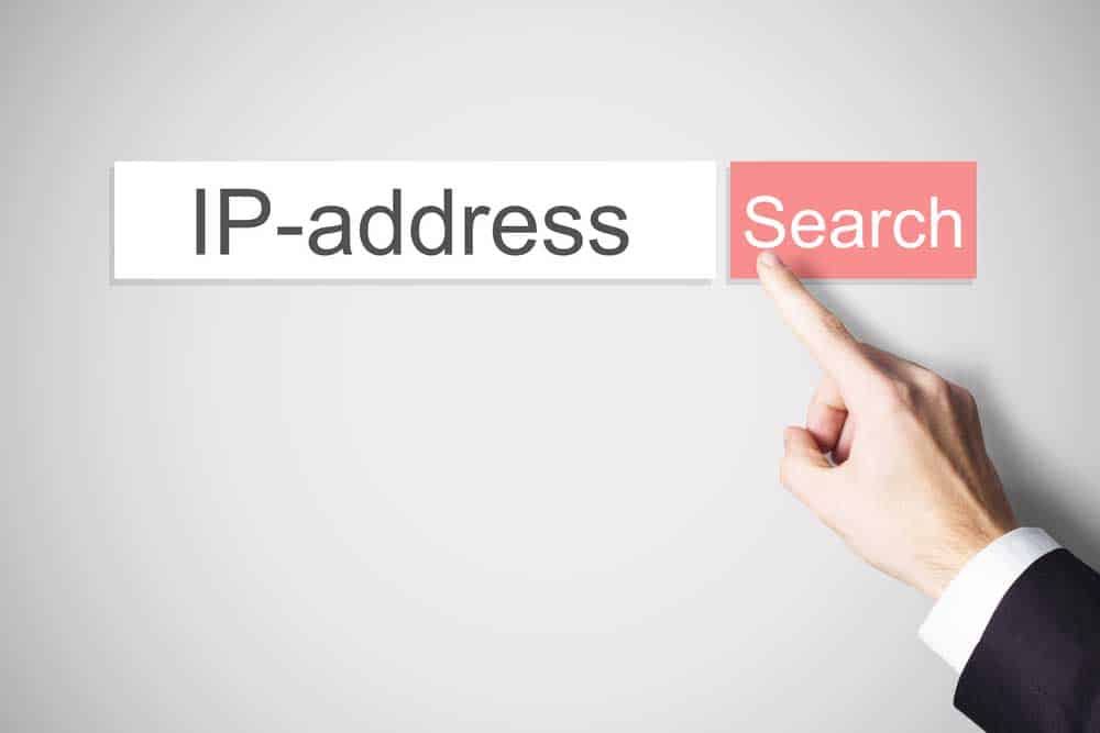 Finger pressing the red search button IP address