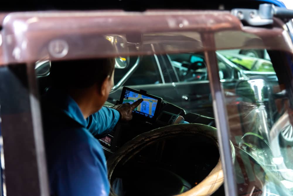 A trucker using a windshield-mounted GPS system