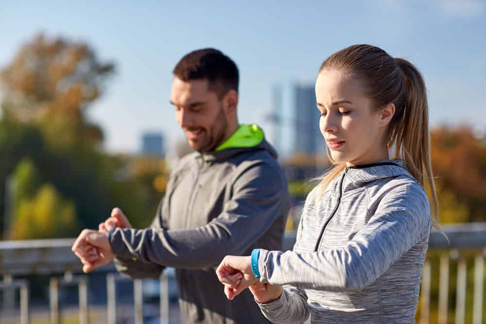 Two people using trackers to monitor fitness progress