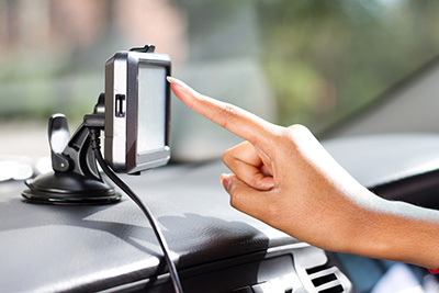 Finger pointing at GPS navigation system
