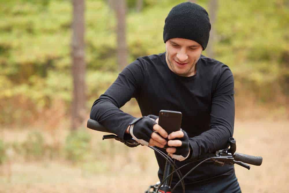 A cyclist checking GPS coordinates on the phone