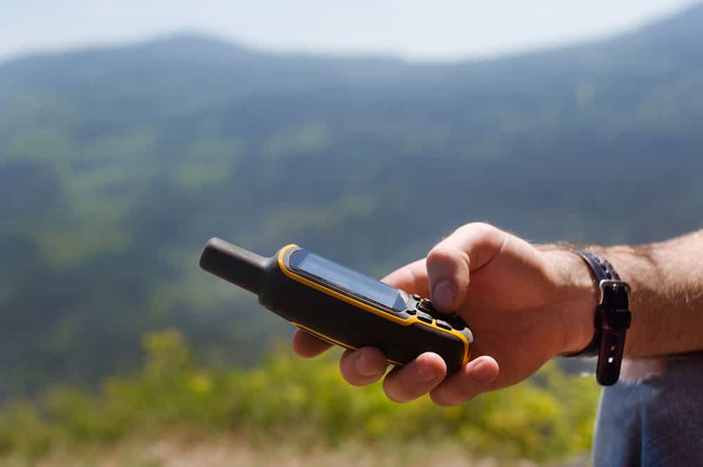 A man holding a hunting GPS unit