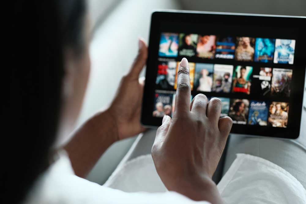 A woman selecting a movie on an internet streaming service