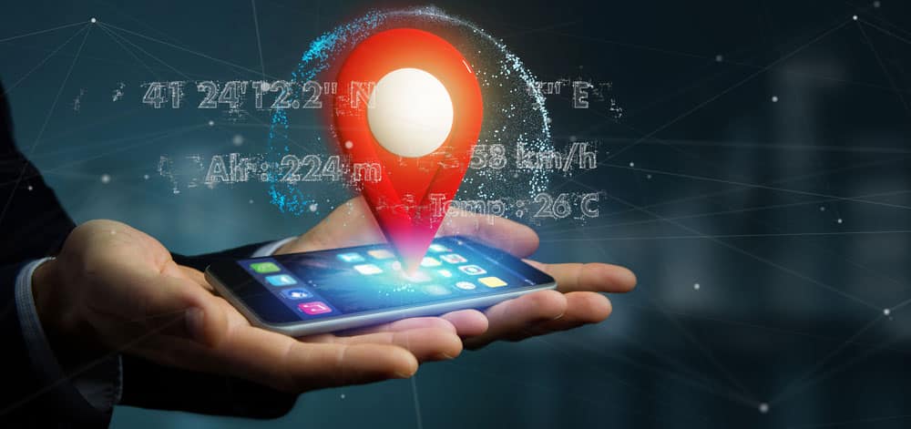 Present GPS Location: Man holding a 3D pin holder on a globe with coordinates.