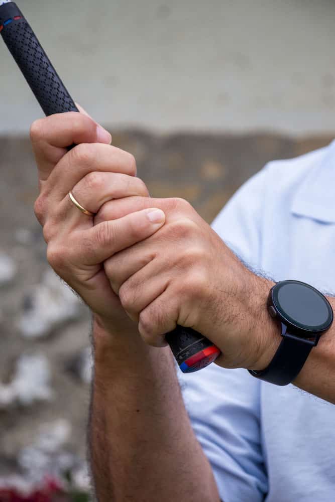 Close-up photo of a golfer wearing a golf GPS watch