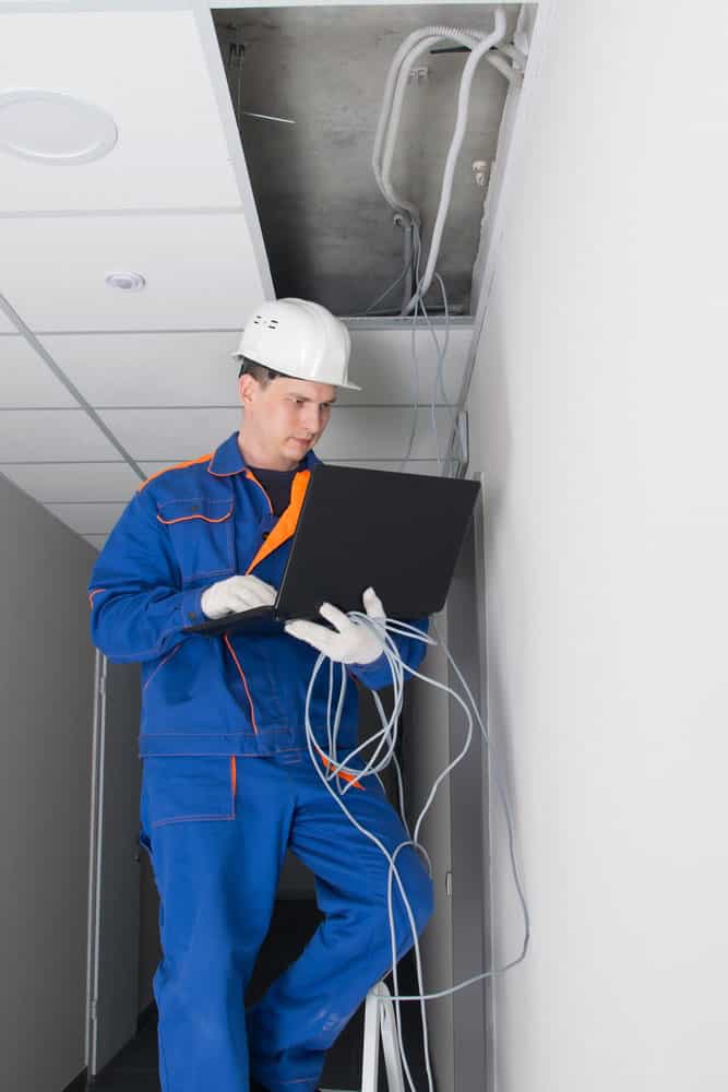 A man installing and configuring a Wi-Fi router