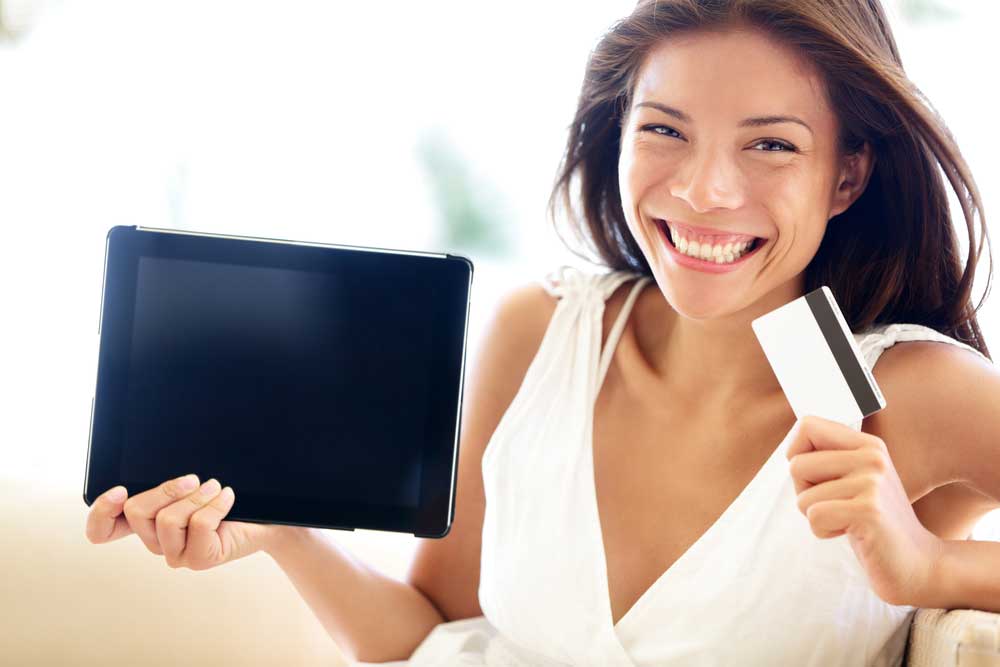 A happy woman shopping for a tablet