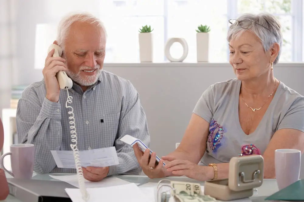 Cheapest Landline Phone Services Without Internet: Elderly couples using a landline phone. 