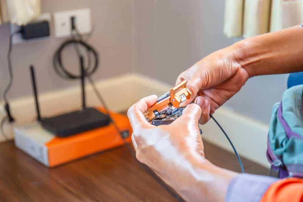 A technician installing fiber internet in a home