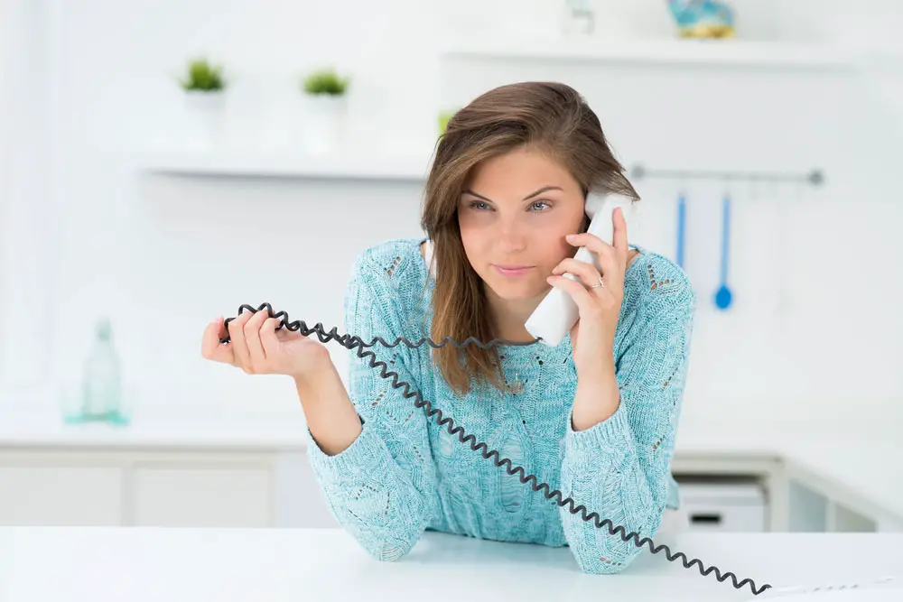 Cheapest Landline Phone Services Without Internet:  A girl on a landline phone call.