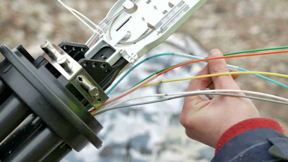 Technicians installing optical fiber cables