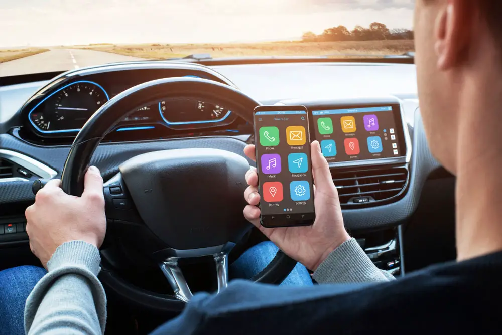 A driver with a phone synchronized to the infotainment system wirelessly