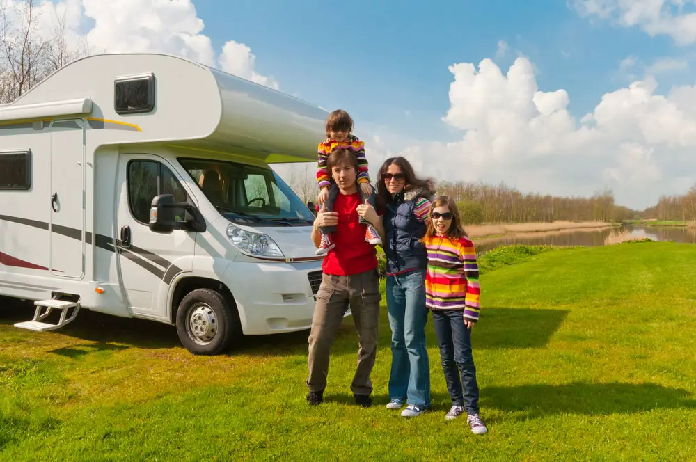 A family outside an RV. 