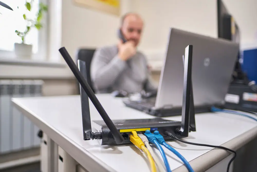 A router with four ethernet cables attached