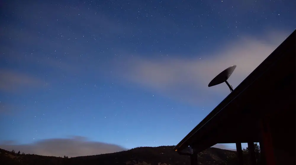 A Starlink antenna mounted above a roof