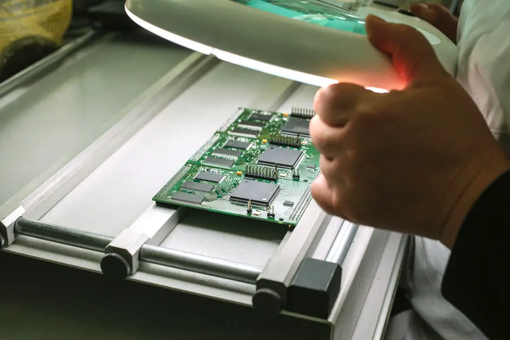 DFM Tools:  A PCB under inspection after fabrication and assembly