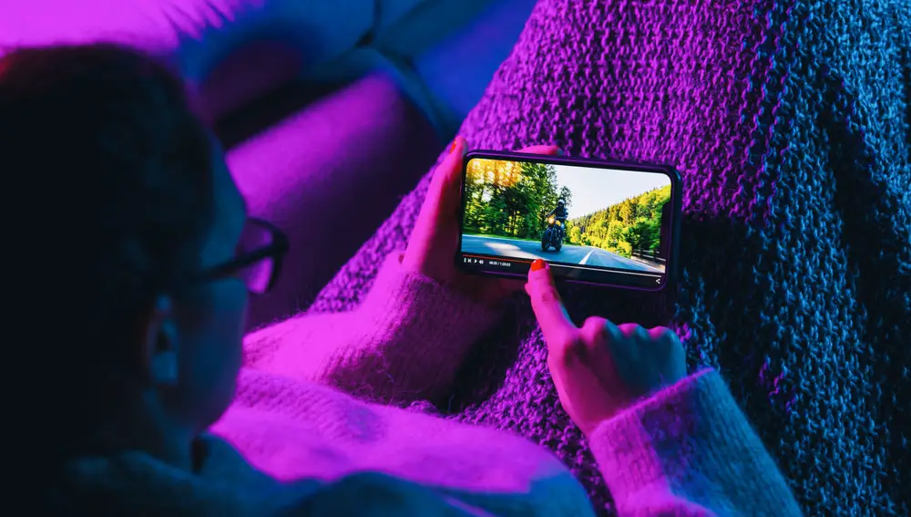 A Young Woman Streams a Movie on the Phone. 