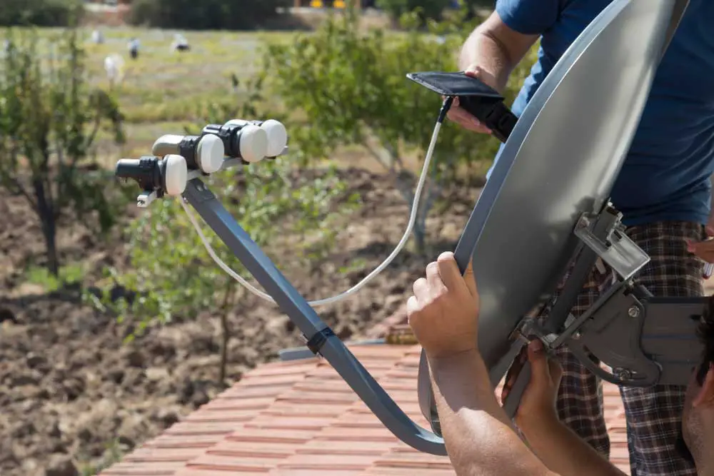 Engineers installing satellite dish antennas