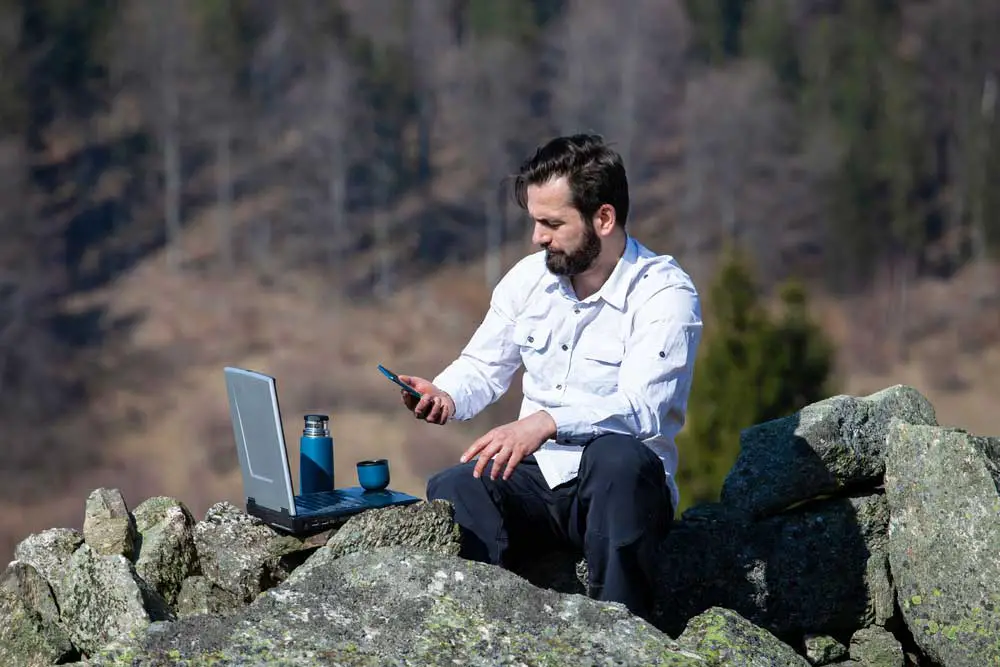 A man working in a remote area with a PC