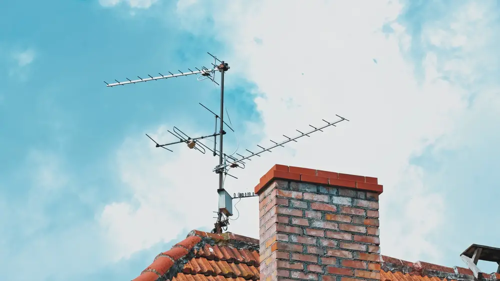 A television antenna over a roof